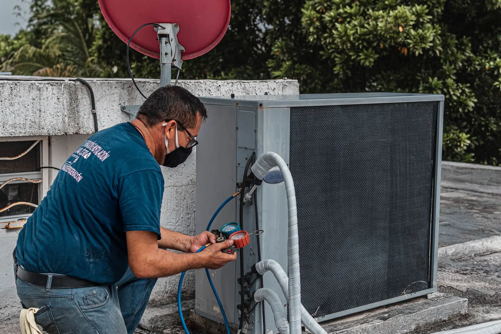 Technician checking an outdoor air conditioning unit