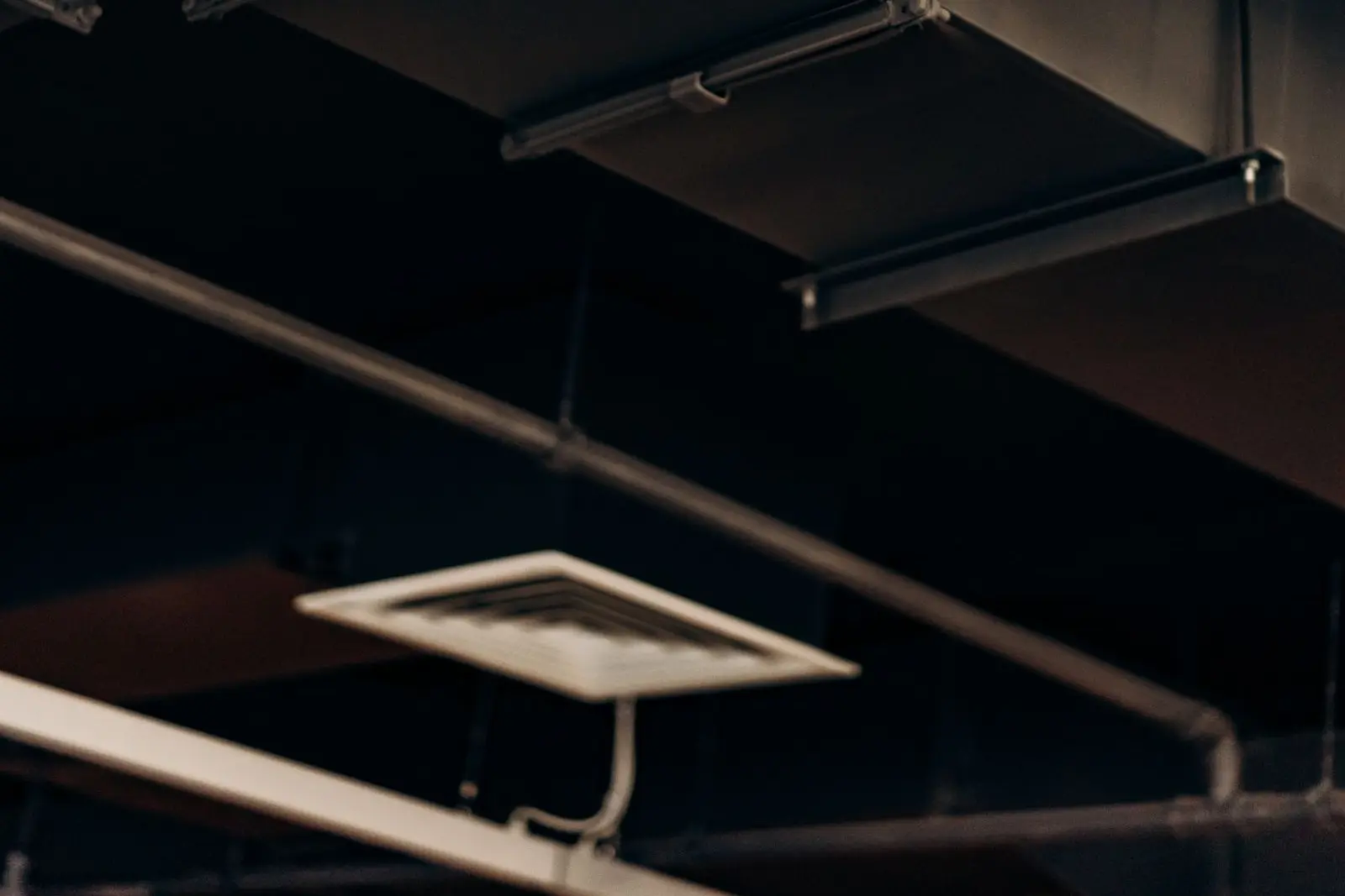 Metal air ductwork running along a ceiling